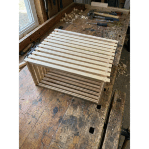 hive frame deep, assembled and wired in a workshop